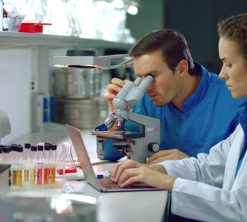 Scientist Looking at Microscope
